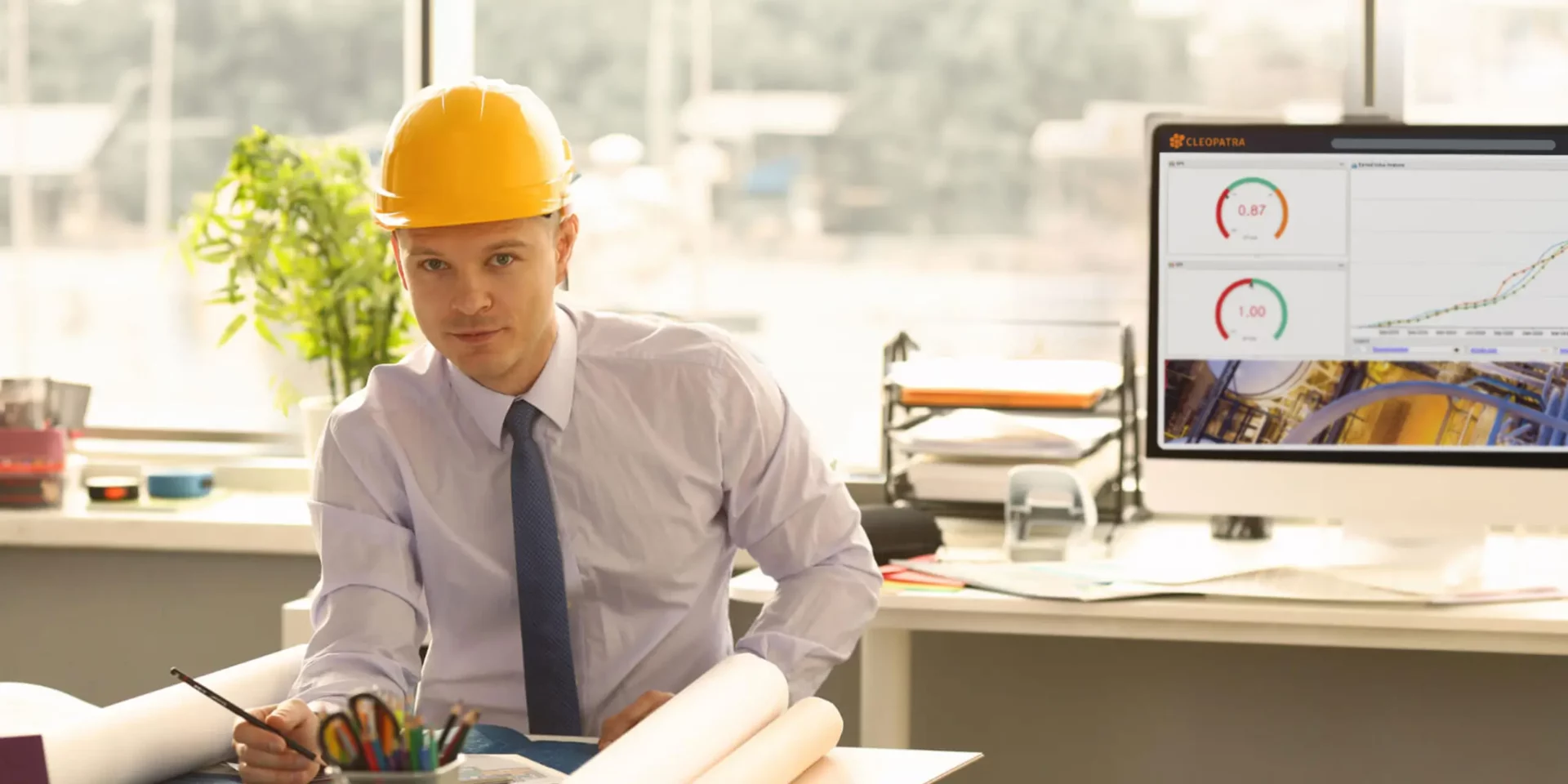 A cost controller supervises a project, using project controls software dashboards to monitor key project metrics