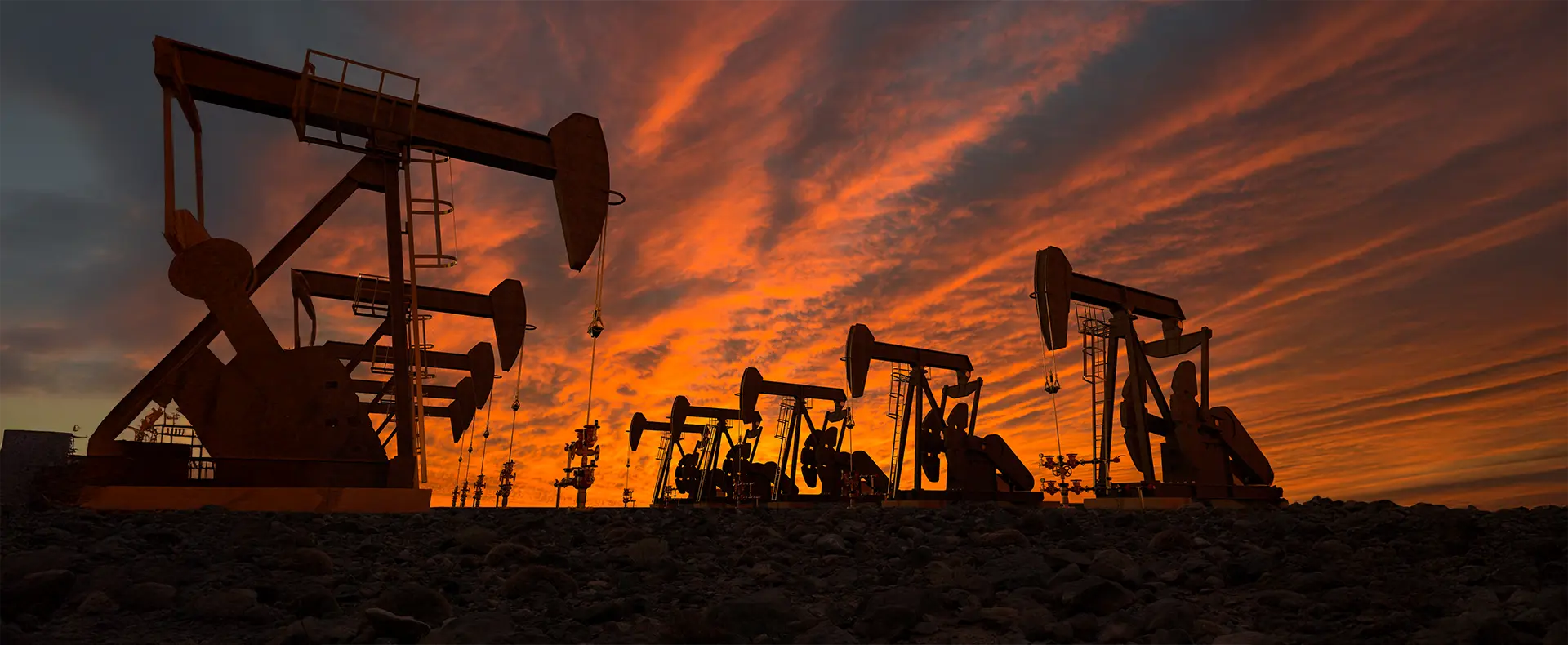 A group of oil pumps at sunset