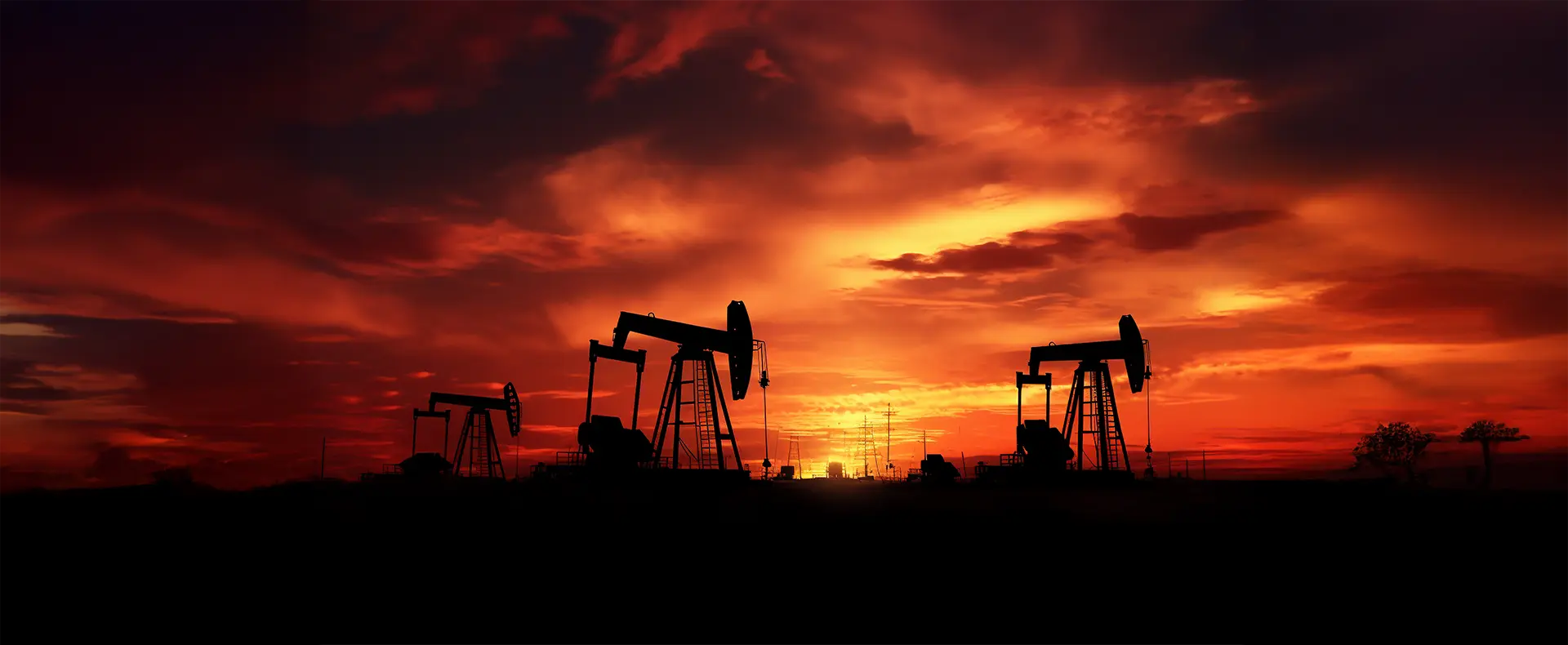 Oil pumps at a project site during sunrise
