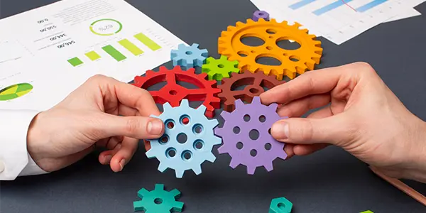 Interconnected gears, which represent operational efficiency in project management.
