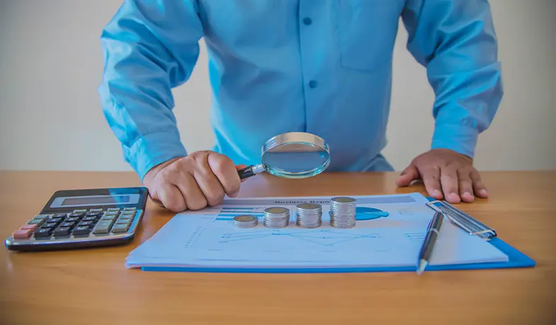 A professional doing project cost tracking on the reports