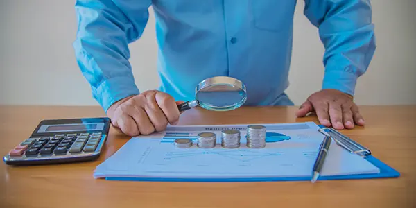 A professional doing project cost tracking on the reports
