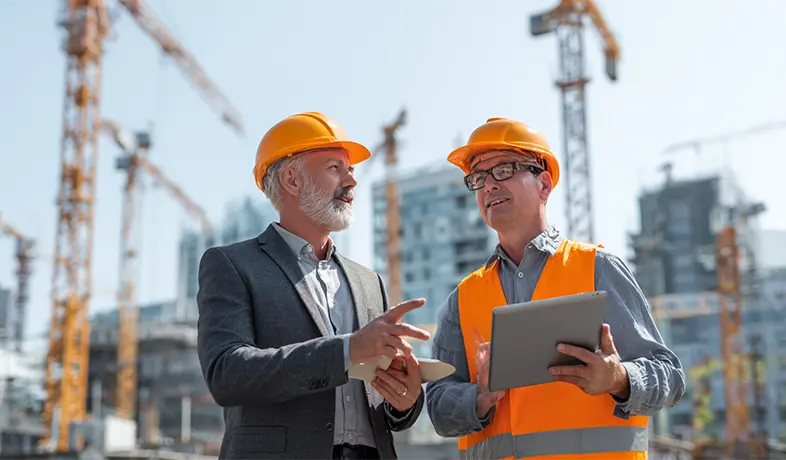 An owner and a contractor collaborating on a construction project.
