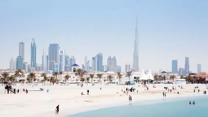 Jumeirah Beach Residence in Dubai, with a sandy beach and people in the shoreline