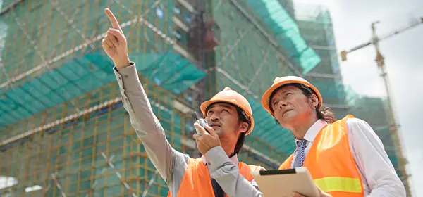 2 professionals checking what's included in a bill of materials (BOM) for a project.