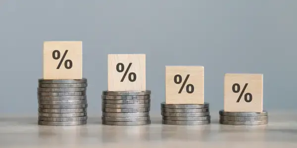 Percentages on top of stacked coins, representing the calculation of contingency budgets