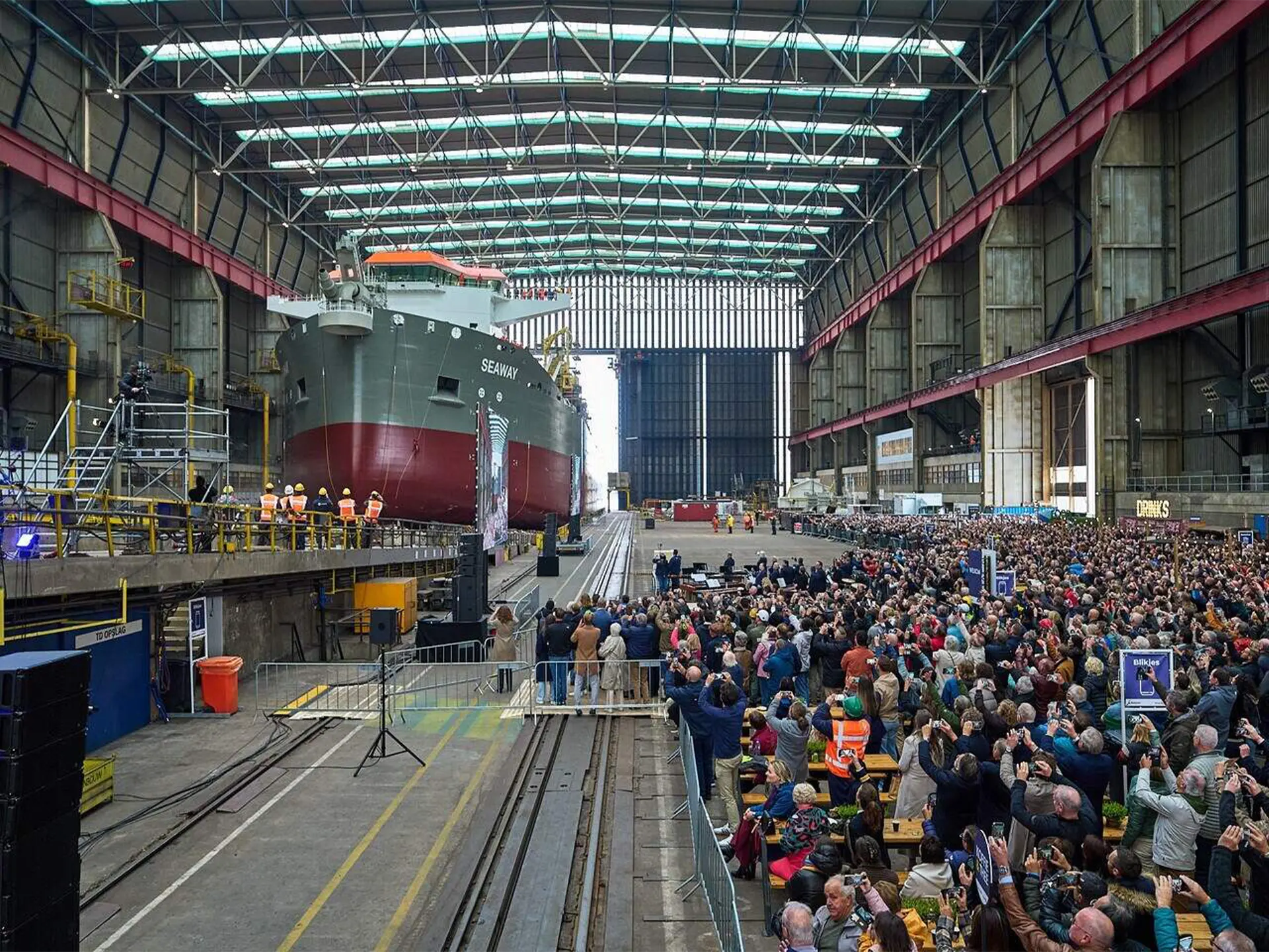 Ship Launch Ceremony of SEAWAY Vessel at Shipyard People celebrating at a shipyard the ship launch ceremony of SEAWAY Vessel