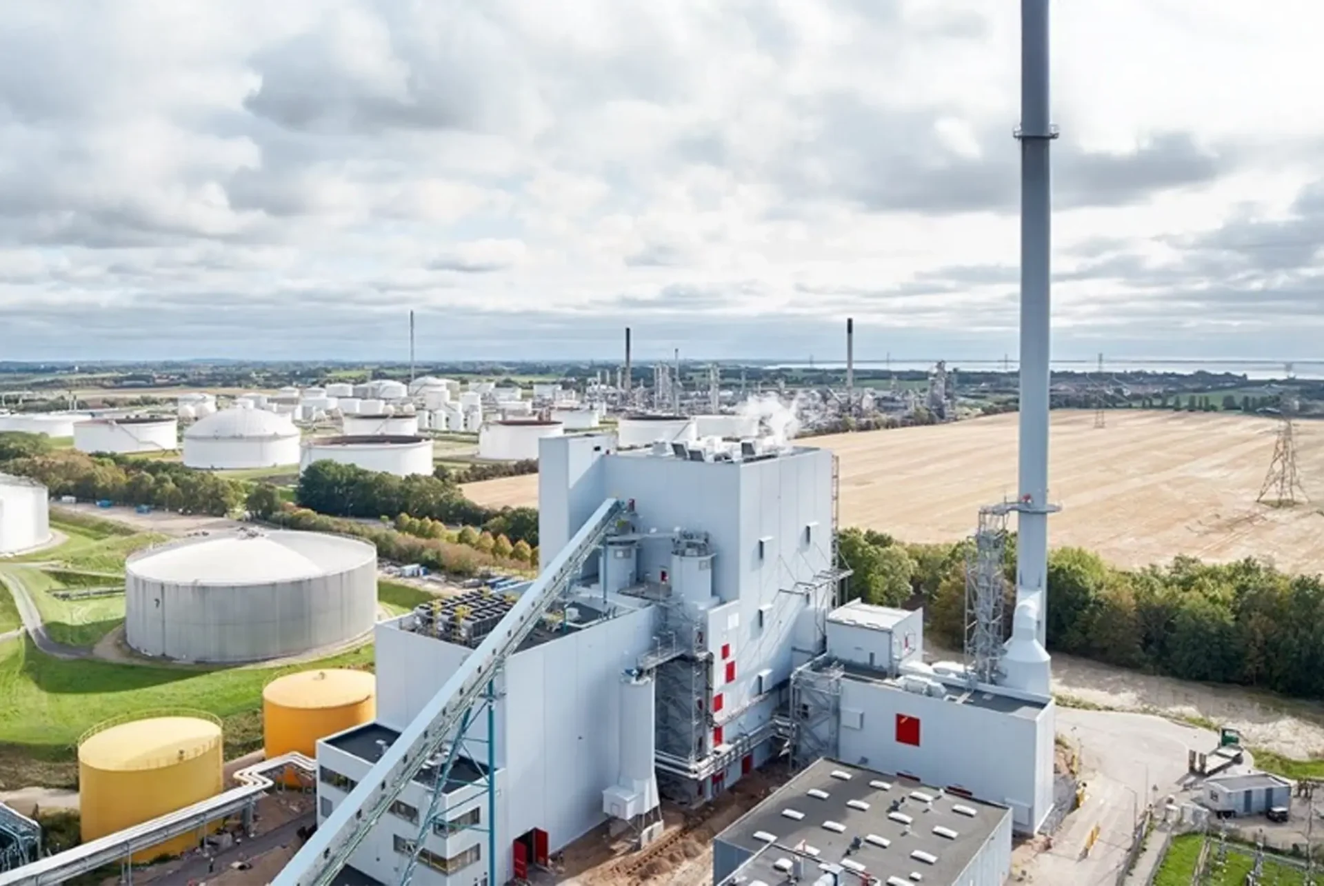 Industrial facility with large storage tanks located in open farmland